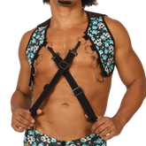 Black gigo comics vest harness with teal and white skull pattern adjustable straps and metal rings visible on front