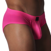 Fuchsia brief in textured, honeycomb-patterned fabric featuring a contoured pouch and a small black rectangular logo.