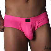 Fuchsia-colored low-rise briefs in textured mesh fabric with a centered black logo patch on the waistband.
