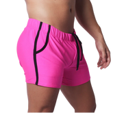 Fuchsia mesh athletic shorts with black trim along the pockets and sides, featuring an elastic drawstring waistband.