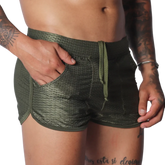 Olive green mesh athletic shorts with a drawstring waist, side pockets, and a short-cut curved hem.
