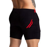 Black athletic shorts with red striped accents on waistband and side pocket gigo f fetish red short