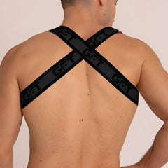 Black gigo fetiche harness back view featuring cross-back straps with get branding in leather material