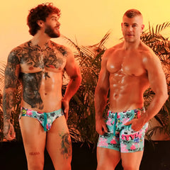 Men wearing gigo figure swim brief swim trunks in teal and pink with vibrant graffiti style and bold lettering