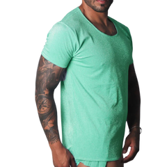 Flash green scoop-neck t-shirt with a metallic, shimmering finish worn by a tattooed man.