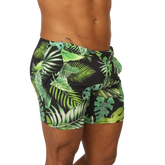 Black swim trunks with vibrant green tropical leaf pattern from Gigo Forest beachwear for summer beach use