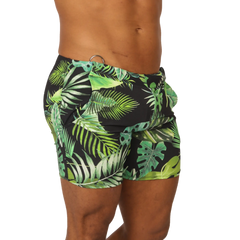 Black swim trunks with vibrant green tropical leaf pattern from Gigo Forest beachwear for summer beach use