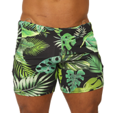 Black swim trunks with vibrant green and lime tropical leaf pattern and metallic silver waistband rings by Gigo Forest