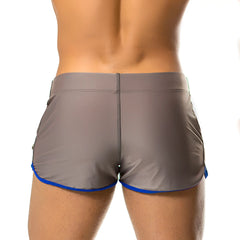 Gigo Hotenc gray beachwear athletic shorts with blue trim along hem and side pockets featuring sleek fit