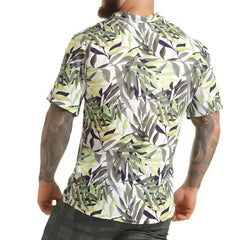 A men’s short-sleeved button-up gigo jungle shirt with vibrant green gray and navy tropical leaf pattern on white background
