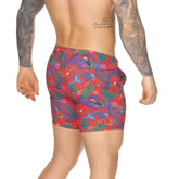 Gigo Macaws red beachwear swim trunks with vibrant blue green purple tropical leaves and toucan print