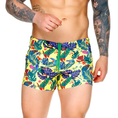 Vibrant yellow gigo macaws swim trunks with tropical blue green red and purple leaf and flower pattern for beachwear