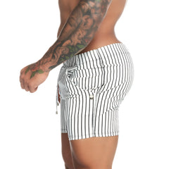 Black and white vertically striped men’s shorts made of stretchy fabric with drawstring waistband
