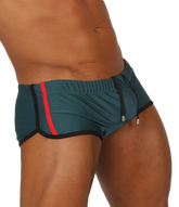Gigo Nice Green swim trunk in teal with a bold red stripe and black trim designed for athletic use