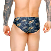 Dark blue gigo palms swim brief with vibrant gold and green tropical leaf pattern for stylish swimwear looks