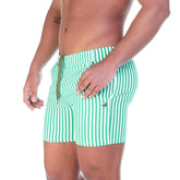 Green and white vertically striped swim trunks with drawstring waistband from gigo polo green beachwear collection