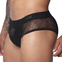 Black men's trunk with floral lace panels, solid waistband featuring a Gigo logo patch, and a contoured pouch design.