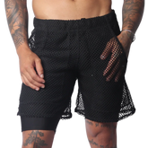 Black athletic shorts with an elastic waistband, featuring a sheer, oversized mesh outer layer over solid lining.