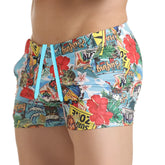 Gigo Seventies beachwear brightly colored swim trunks with tropical collage print on light blue fabric
