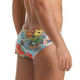 Gigo Seventies swim brief vibrant tropical men’s swim trunks with colorful surfboards pineapples and floral patterns