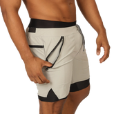 Light gray gigo sporty shorts with black trim and zippered side pocket for athletic use