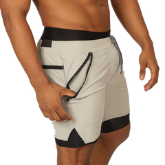 Light gray gigo sporty shorts with black trim and zippered side pocket for athletic use