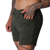Forest green, slim-fit shorts in a matte stretch fabric with a button closure and classic five-pocket construction.