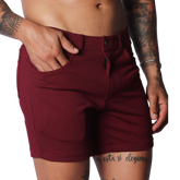 Wine-colored, short-length casual shorts in a smooth, stretch fabric with a button-fly closure and belt loops.