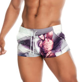 White and purple graphic swim trunks featuring a muscular male illustration from gigo super daddy brown beachwear