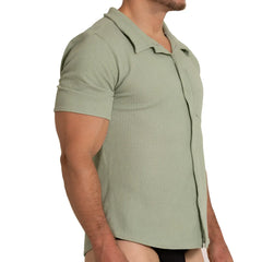 A men’s short-sleeved polo shirt in muted sage green with textured waffle knit and classic collar gigo tissue green shirt