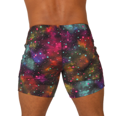 Vibrant gigo universe beachwear galaxy-print shorts with pink purple teal and orange nebulae and sparkling stars
