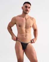 Black glide micro brief thong with white repeating text waistband showing back side