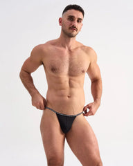 Black glide micro brief thong with white repeating text waistband showing back side