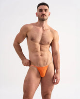 Bright orange Glide micro brief thong with thin matching elastic waistband made from smooth breathable fabric
