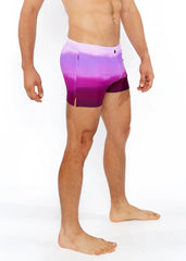 Purple gradient printed swim shorts with white to purple tie dye pattern and side slit for casual beachwear
