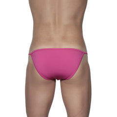 Bright pink form-fitting groovin string bikini swim trunks with a thin elastic waistband in fuchsia pink