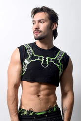 Black harness crop top with neon green leather-like straps and silver hardware featured from the back side