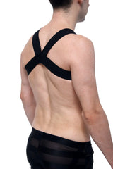 Black harness petitq givet love with cross-back support strap worn over shoulders shown from the back side