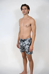 Men’s dark gray Hawaiian print swim short with white tropical leaf pattern and black drawstring waistband