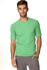 A men’s short-sleeved green ribbed bamboo hybrid crew neck raglan athletic tee with rolled-up sleeves