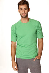 A men’s short-sleeved green ribbed bamboo hybrid crew neck raglan athletic tee with rolled-up sleeves