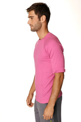 A vibrant pink hybrid crew neck raglan tee with short sleeves and rolled cuffs designed for athletic use