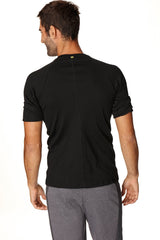 Black hybrid crew neck raglan tee back view with short sleeves, subtle vertical seam, and small green neckline logo