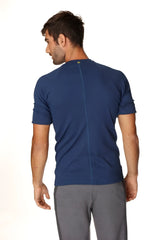 Navy blue short-sleeved athletic hybrid crew neck raglan tee shown from the back with a central seam for activewear use