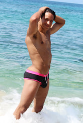 Black swim trunks with vibrant fuchsia trim and white drawstring from icker sea cheeky bikini swimwear collection