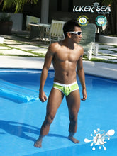 Bright lime green icker sea swim trunks with white waistband and front pouch featuring contrast trim and stitching