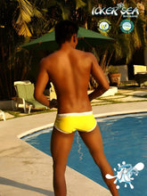 Bright yellow icker sea cord swim trunks with white contrast trim and stitching for beachwear
