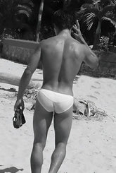 A man wearing icker sea duotone bikini swimwear white briefs on a beach in blue cob-15-22 design