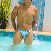 Icker Sea Flowers thong swimwear in blue with white floral pattern and red accents for beachwear use