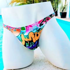 Icker Sea graffiti thong swimwear in vibrant pink orange teal and purple graffiti-patterned fabric